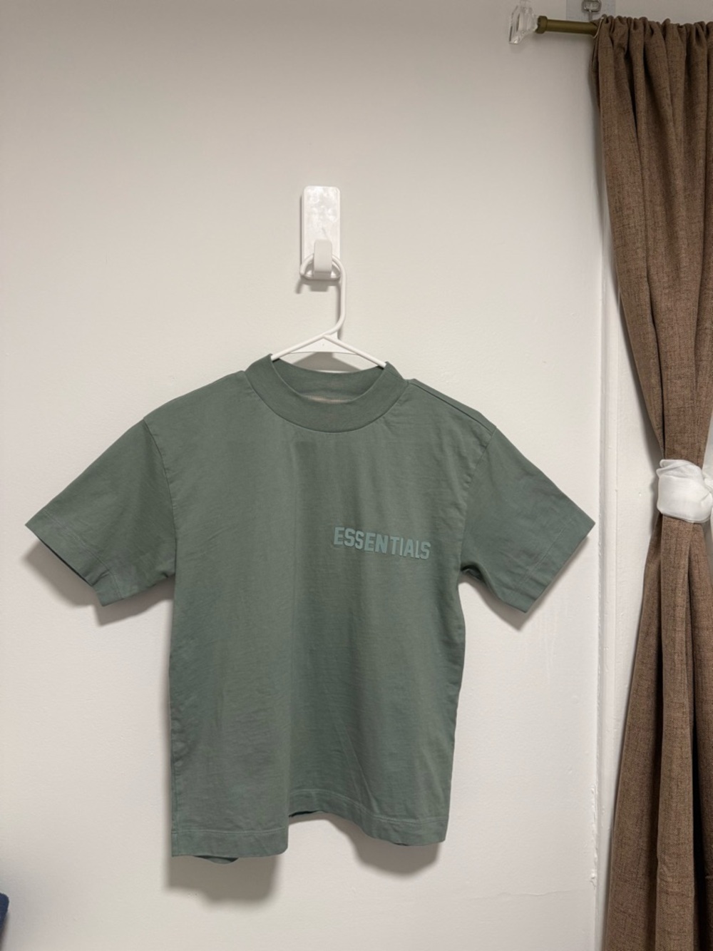 Fear of God ESSENTIALS Women’s Medium Sage Gray (actually a greenish) t-shirt.
